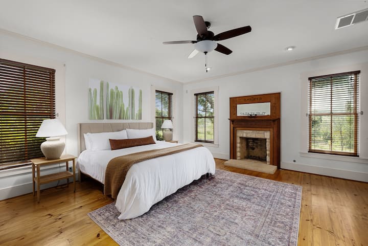 Here is the restful primary bedroom at our Luxurious Home on Adobe Creek. This Ranch home ensures you have a true good nights sleep on a comfortable king bed with a full view of the surrounding land.