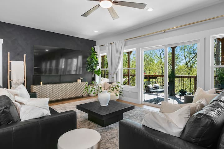 Enjoy the cozy ambiance of the downstairs living area, featuring comfortable leather sofas and a large TV for your entertainment.