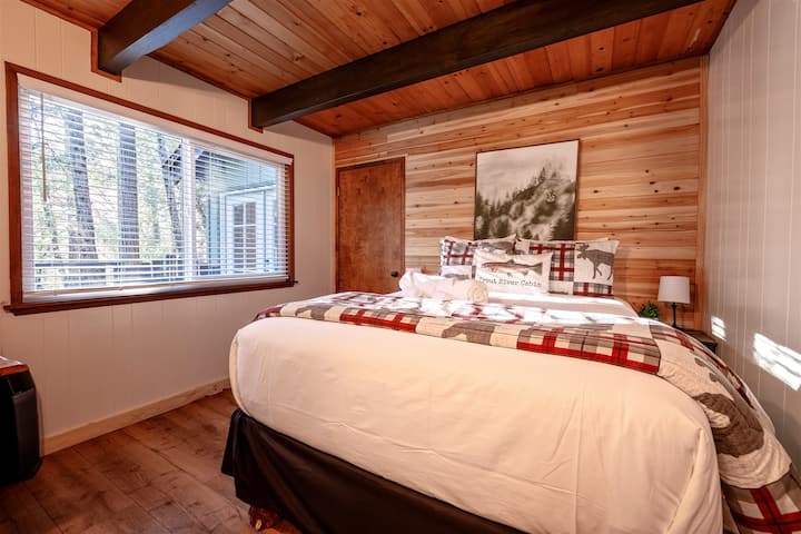 Main Bedroom Retreat – Spacious and serene, with wood textures and forest views.
