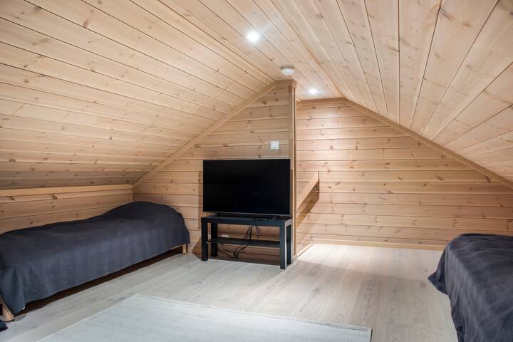 Separate loft with four single beds, a two-seater sofa and a TV with extra HDMI cable if you want to connect your own Apple TV, Google Chromecast or game console.