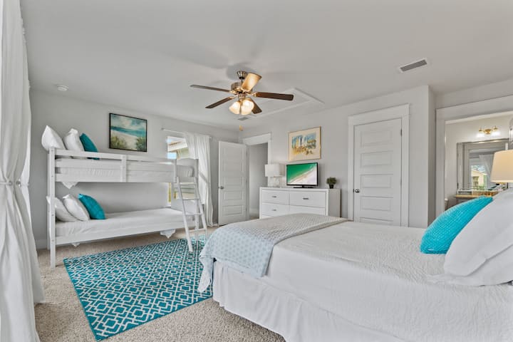 Flat screen TV, walk in closet and game wall in the hall outside of the bunkroom.