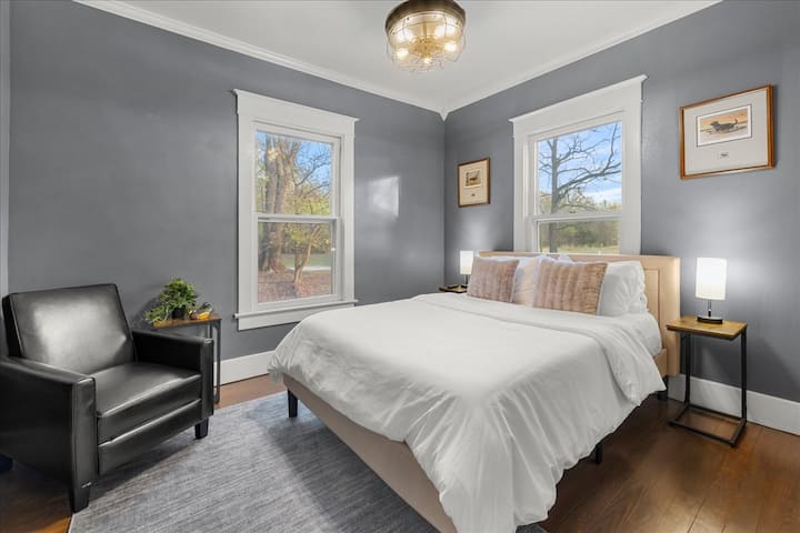 Bedroom 1: Located on the first floor, this bedroom is features a queen-size bed and two night stands.