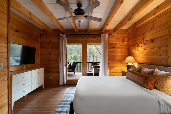 Enjoy views from this main level Queen bedroom with access to the main deck. Features a ceiling fan, closet, TV, dresser and access to a shared full bathroom.