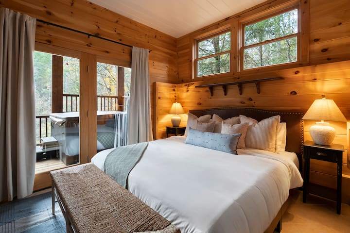 Enjoy a view from this lower bedroom with King bed, TV, dresser and private full bathroom with access to the lower deck.