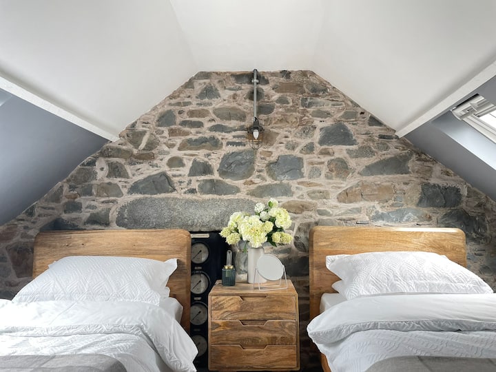 A cosy but perfectly formed 2nd bedroom with twin beds, original stonework, oak beams. Direct open access from the stairs