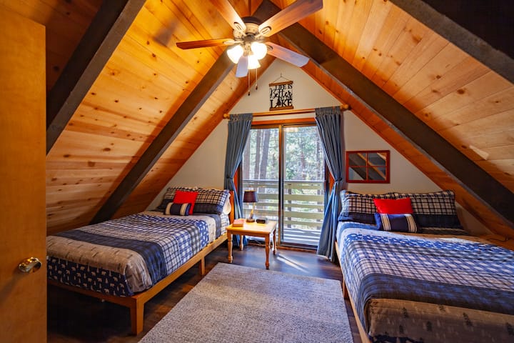Cozy camp style bedroom with balcony in the trees. A great place to have coffee in the morning and listen to the birds and chipmunks.