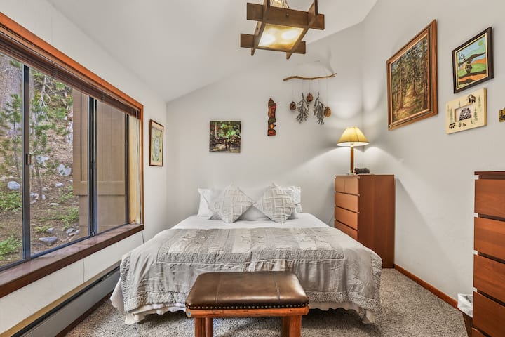 Bright bedroom with a cozy queen bed, soft linens, and natural light.