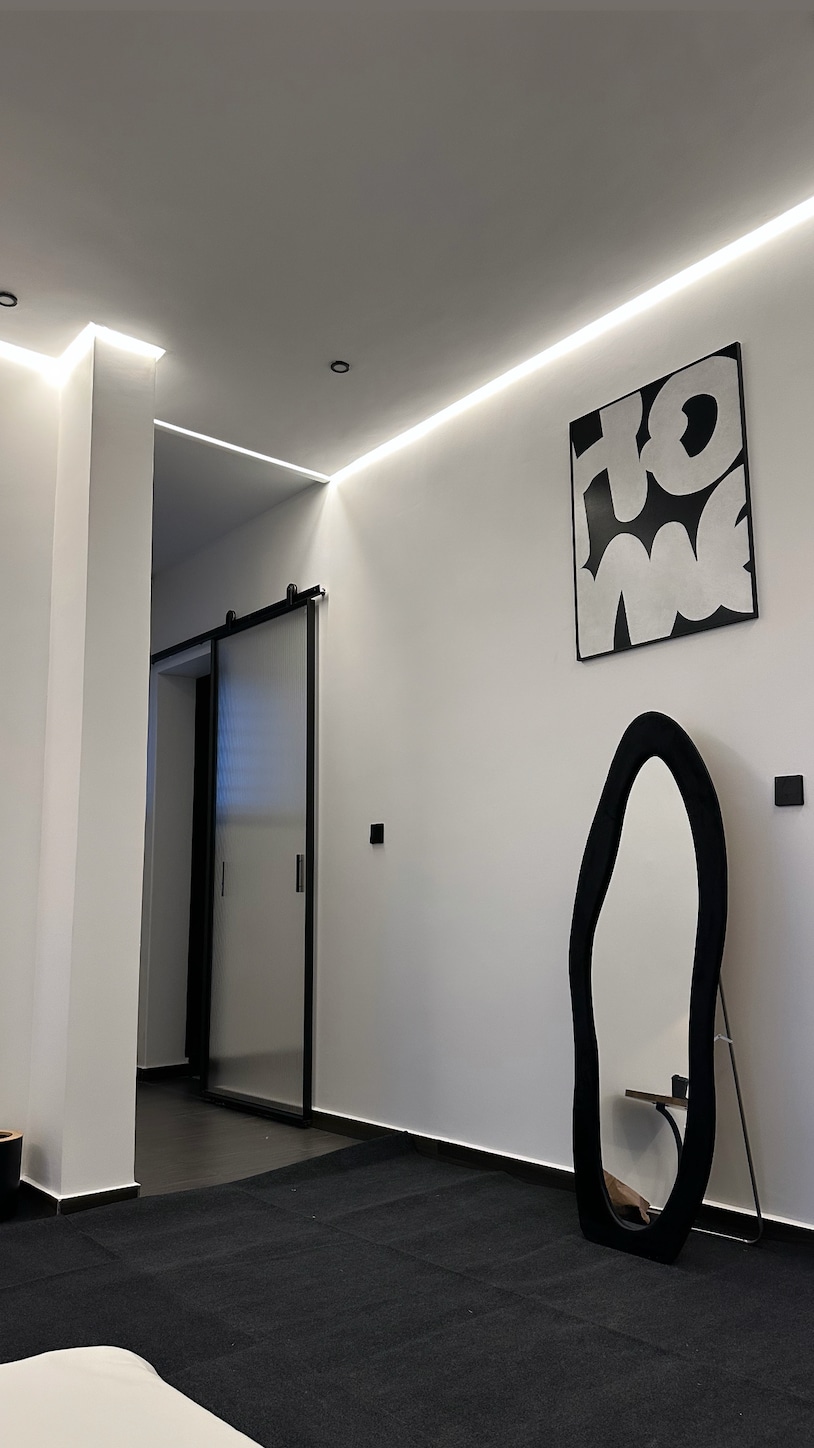 Home art paired with a minimal mirror adds a touch of elegance and depth, blending creativity with modern simplicity.
