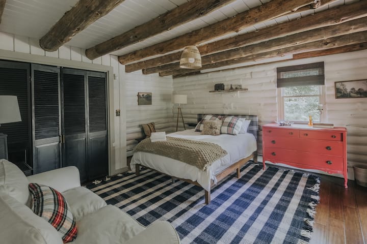 This main-floor bedroom offers a quiet sense of separation from the upstairs rooms. Wake up to soft morning light and pond views just beyond the sliding glass doors.