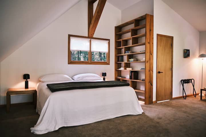 Welcome to the primary suite. Wake up on a king-sized mattress with 400 thread count sheets and premium pillows. Enjoy beautiful views of the forest. 