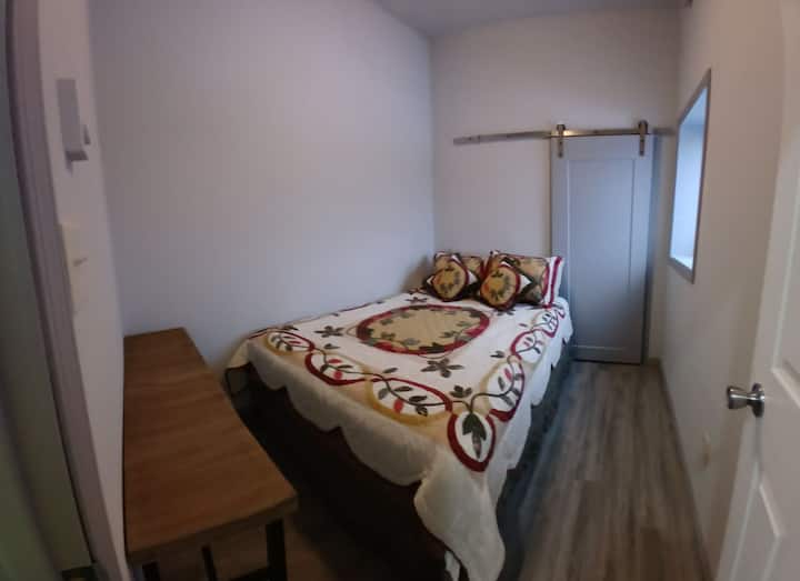 Window looks to the West. Great sunset view overlooking the tree tops and roofs of the neighborhood, but will not get the morning sunrise. Great for sleeping in.  Queen bed. Room has its own thermostat for temperature control.