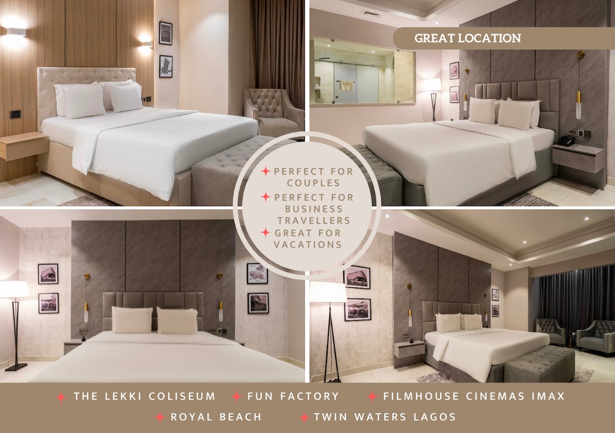 A modern king-sized bed is centered in a well-lit room, complemented by subtle wall decor and soft lighting. The spacious layout includes bedside tables and reading lamps, providing a comfortable atmosphere. Windows allow natural light to enhance the inviting design.