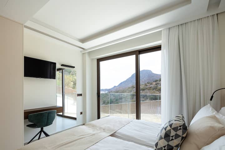 The bedroom on the ground floor of the Alfa home a small balcony