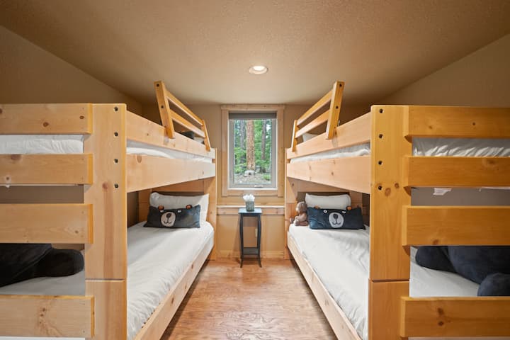 This stylish bunk bed set is designed to maximize space while providing a cozy sleeping environment, perfect for children's room or larger group.