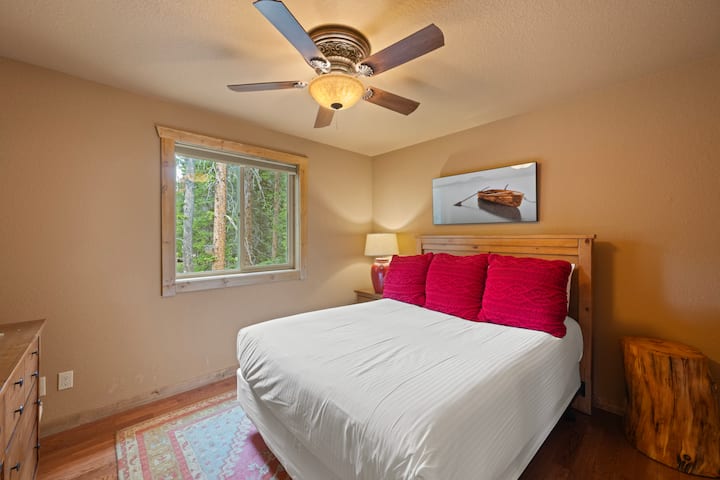 Our bedroom features a comfortable bed, perfect for restful nights, complemented by a stylish ceiling fan that enhances airflow and adds a modern touch.