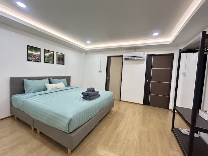 Bedroom 3: Features 1 king-size bed with quality bed sheets, an ensuite bathroom, a balcony, and a closet.