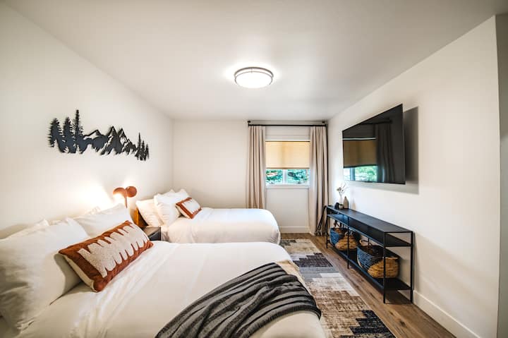 This room includes two full size beds with all-natural hybrid mattresses, 65" TV equipped with Roku streaming, and windows with privacy roller shades and room-darkening curtains.
