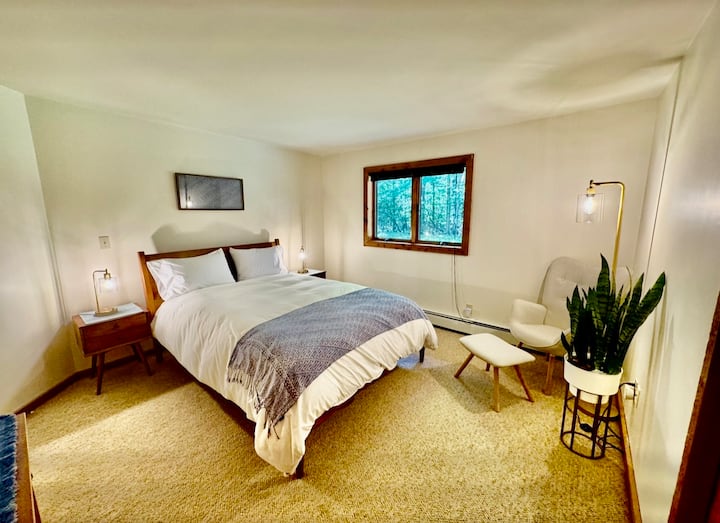 Downstairs 4th Bedroom with sitting area and window overlooking backyard.