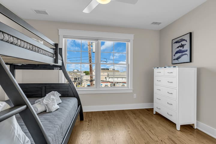 Watoto watapenda chumba hiki cha kulala chenye mwangaza na cha kufurahisha, kilicho na kitanda cha ghorofa na hifadhi ya kutosha. Mapambo ya pwani ya chumba huunda mazingira ya kupumzika.