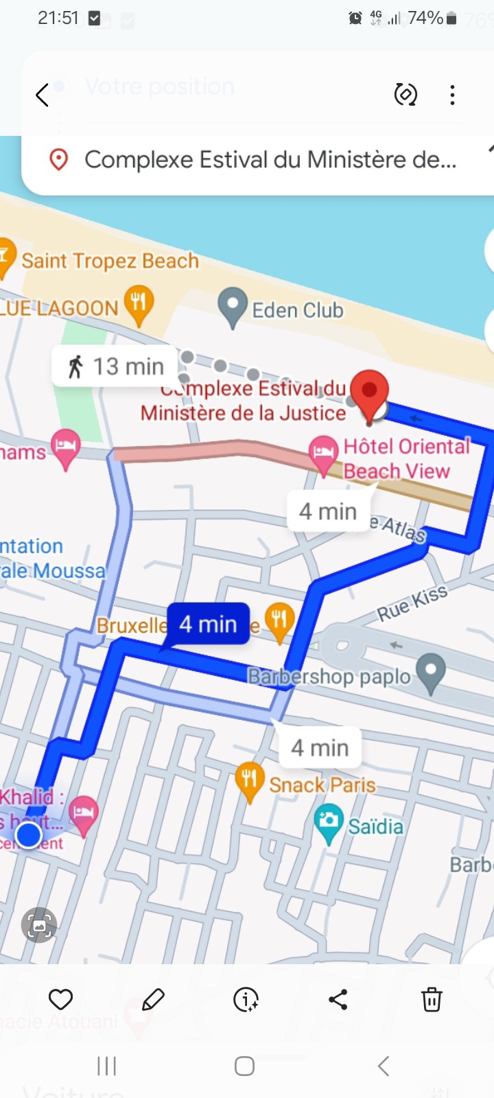 A map is displayed, showing a route highlighted in blue. Key locations such as 'Complexe Estival du Ministère de la Justice' and 'Hôtel Oriental Beach View' are indicated, along with estimated travel times. Surrounding streets and landmarks are also visible.