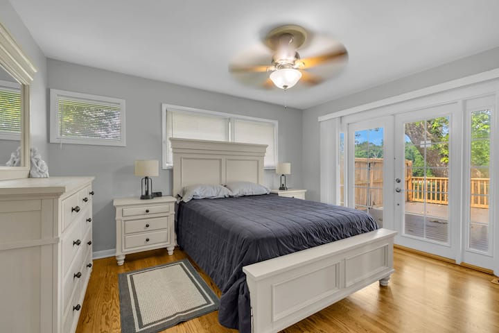 Bedroom 2: Queen bed with a view of a big deck outside