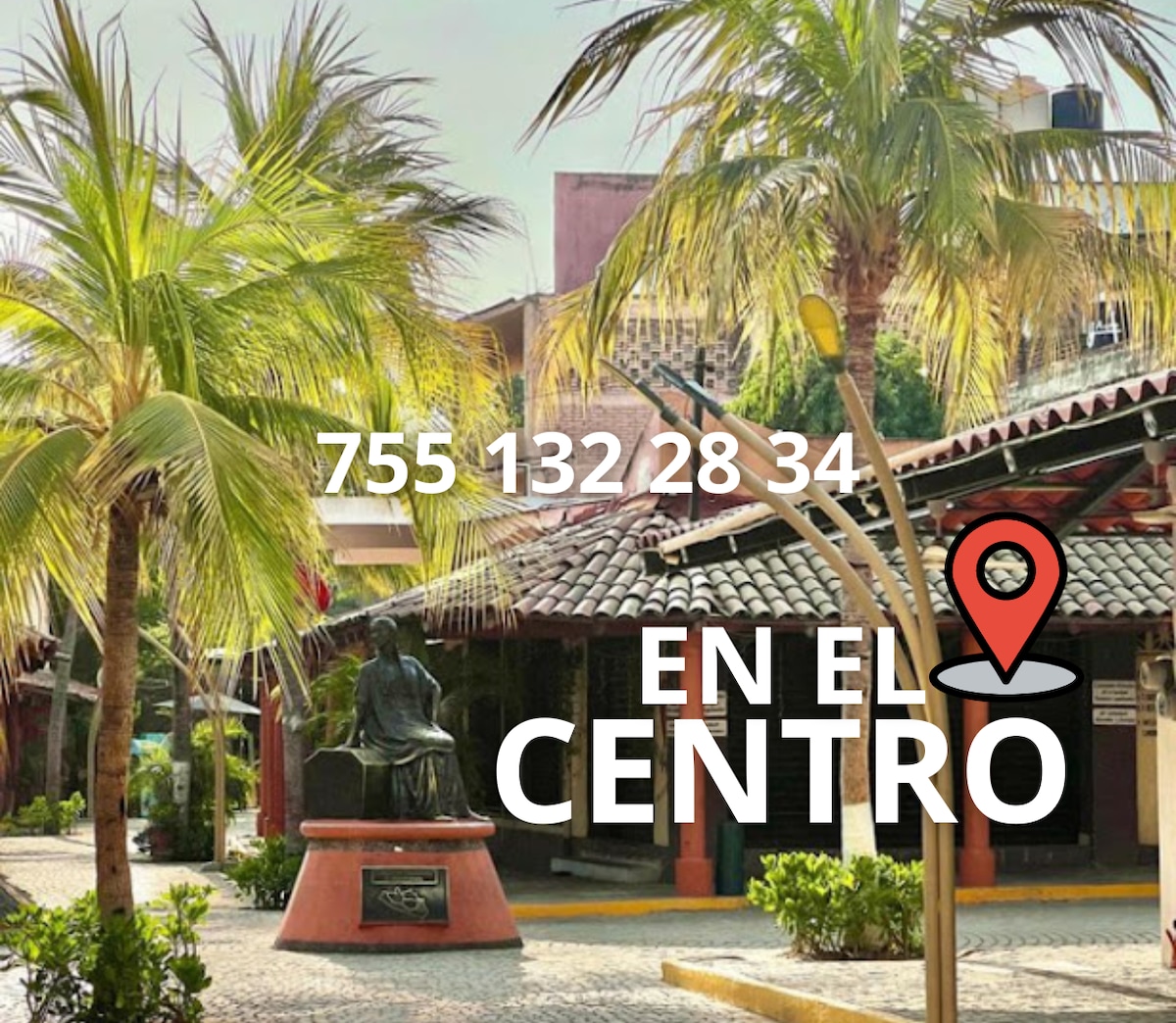 A serene courtyard features palm trees and a statue, surrounded by traditional architecture. The brick pathways lead through the inviting space, showcasing the vibrant atmosphere of the center. Bright sunlight enhances the scenic view, creating an inviting environment for relaxation and exploration.