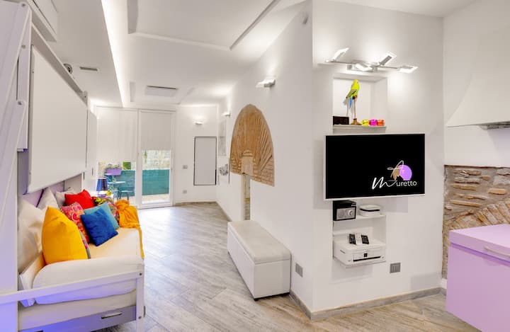 Living Area: Bright and airy space featuring vibrant decor, smart TV, and direct balcony access!
