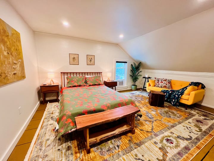 Third bedroom features a queen spindle-back bed, with hotel-quality linens