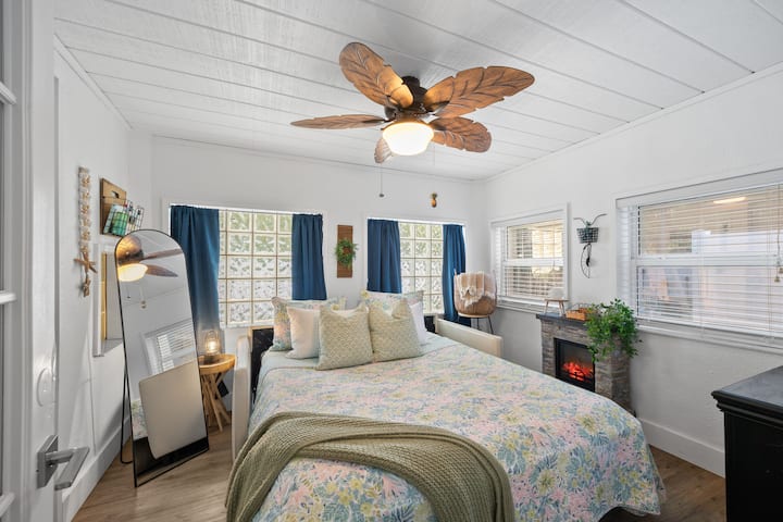 Our beautiful, romantic & cozy Florida Room. This comfortable pull out mattress is QUEEN size, the couch is leather & no need to remove any cushions! Turn on the electric fireplace for warmth and/or ambiance, black out curtains & ceiling fan