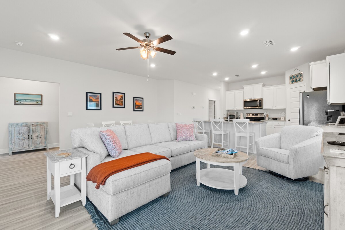 Cozy up after beach days in a sunlit living room made for naps, novels, and late-night laughter.