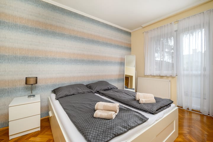 Pohodlná manželská posteľ a balkón.