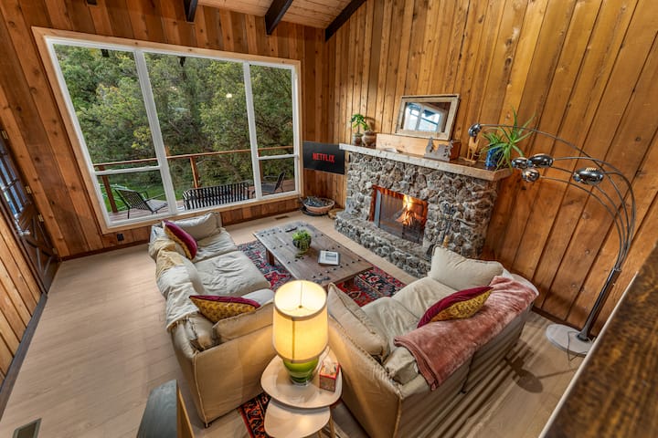 Il nostro accogliente soggiorno di montagna con un caminetto in pietra scoppiettante, il luogo perfetto per rilassarsi dopo aver sciato o immerso nelle sorgenti termali.