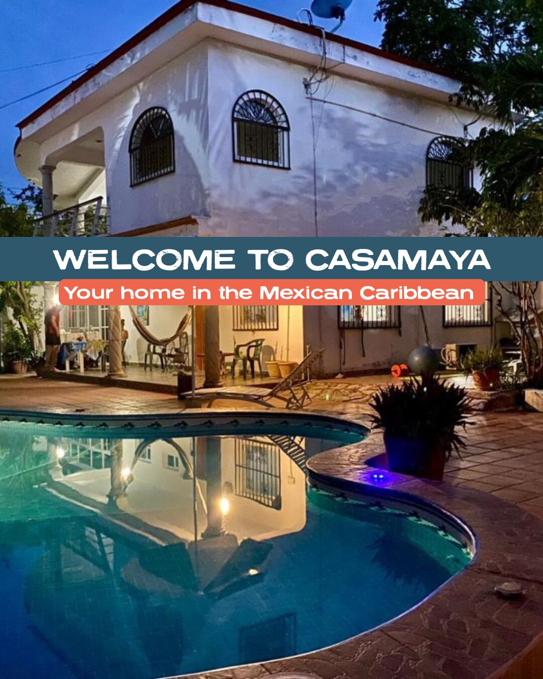 The exterior of Casamaya Hostel & Diving is illuminated at night, showcasing a swimming pool featuring clear water. The welcoming atmosphere is enhanced by the building’s architecture and surrounding greenery, creating a serene setting for relaxation and enjoyment.