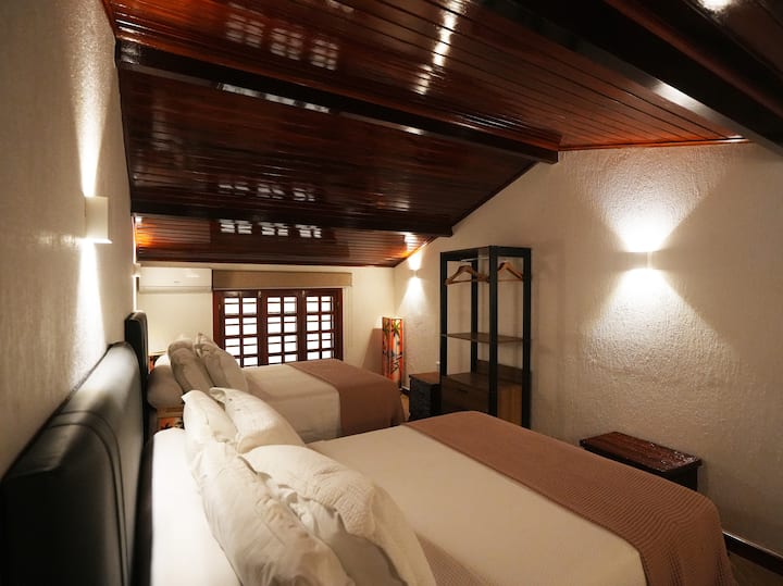 ห้องนอนอบอุ่น แสงสว่างนุ่มนวล เตียงควีนไซส์ 2 เตียง เพดานไม้ ผนังหน้าต่าง บรรยากาศเงียบสงบ 
ห้องพักอบอุ่น แสงสว่างนุ่มนวล เตียงควีนไซส์ 2 เตียง เพดานไม้เคลือบเงาและผนังกระจก บรรยากาศเงียบสงบและน่าอยู่