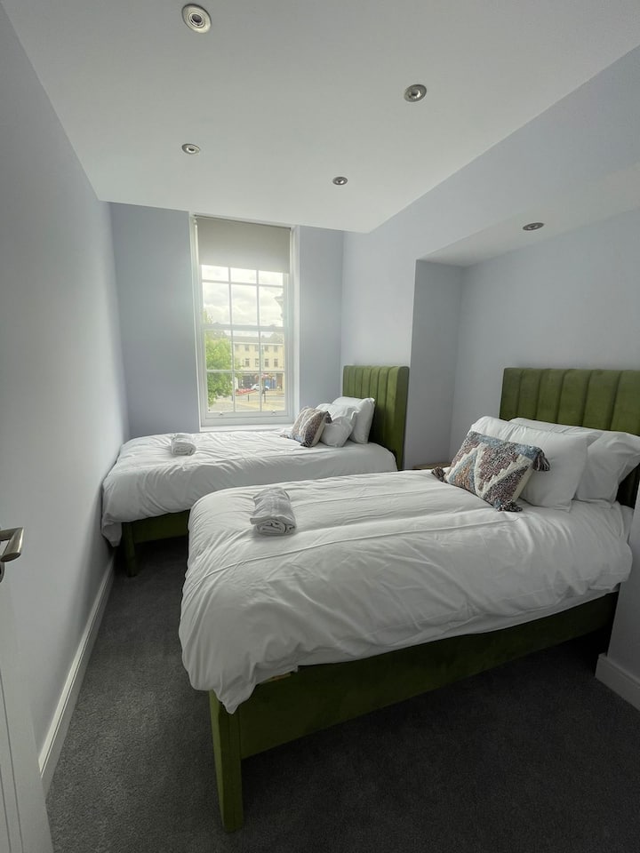 Escape to Bedroom 2, where two cosy single beds await you, accompanied by crisp beddings and fluffy towels - a tranquil retreat for a peaceful night's rest.