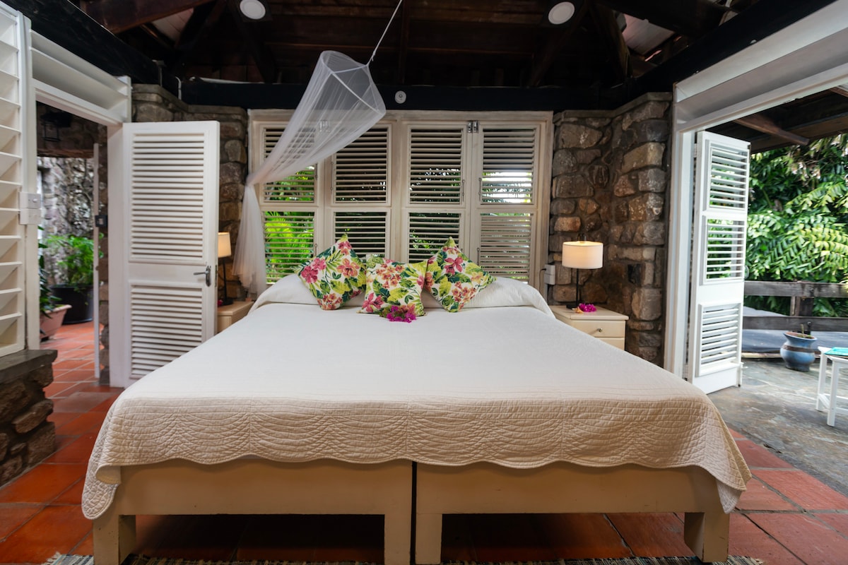 Bougainvillea Suite with private deck overlooking the pool area and gardens