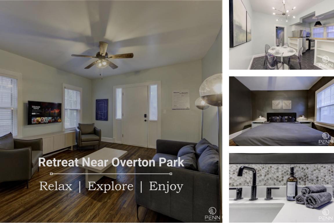 A spacious living area features a ceiling fan, comfortable seating, and a large TV mounted on the wall. Natural light flows through two windows, creating a bright and inviting atmosphere. The open floor plan connects seamlessly to the dining area and kitchen.