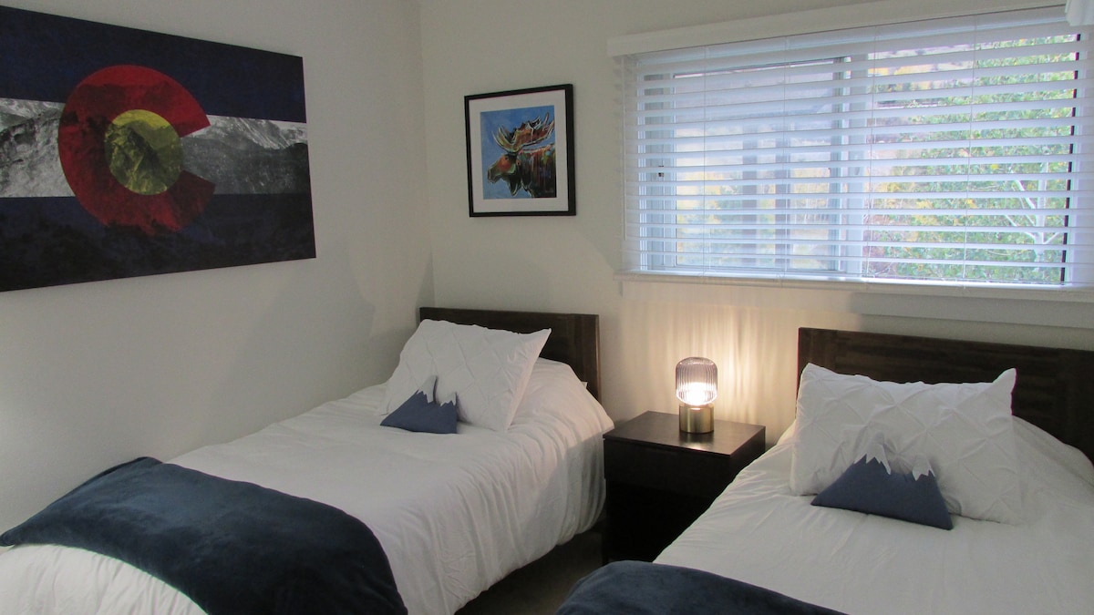 Two twin beds and closet, and nite stand with plenty of extension cords for charging electronics. 