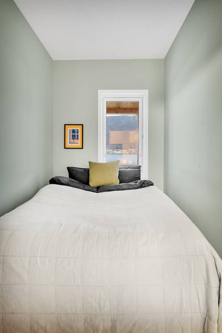 The downstairs guest bedroom features a comfortable queen size bed. Also, after the picture was taken we have installed blackout curtains in the window.