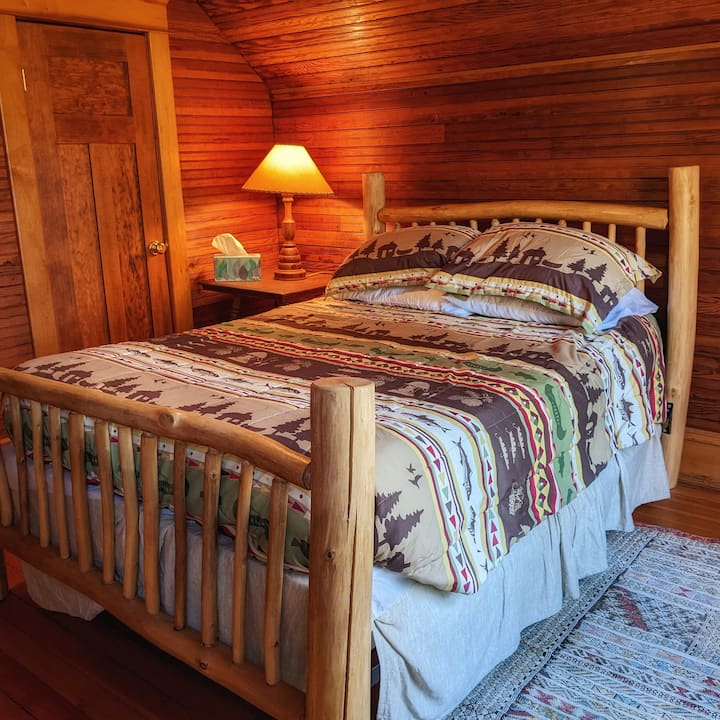 The "stick bed" made from trees on the property, is the room to the left at the top of the stairs. Across from this bedroom is a small "quiet room" with a daybed and lamp that you can use to read or nap.