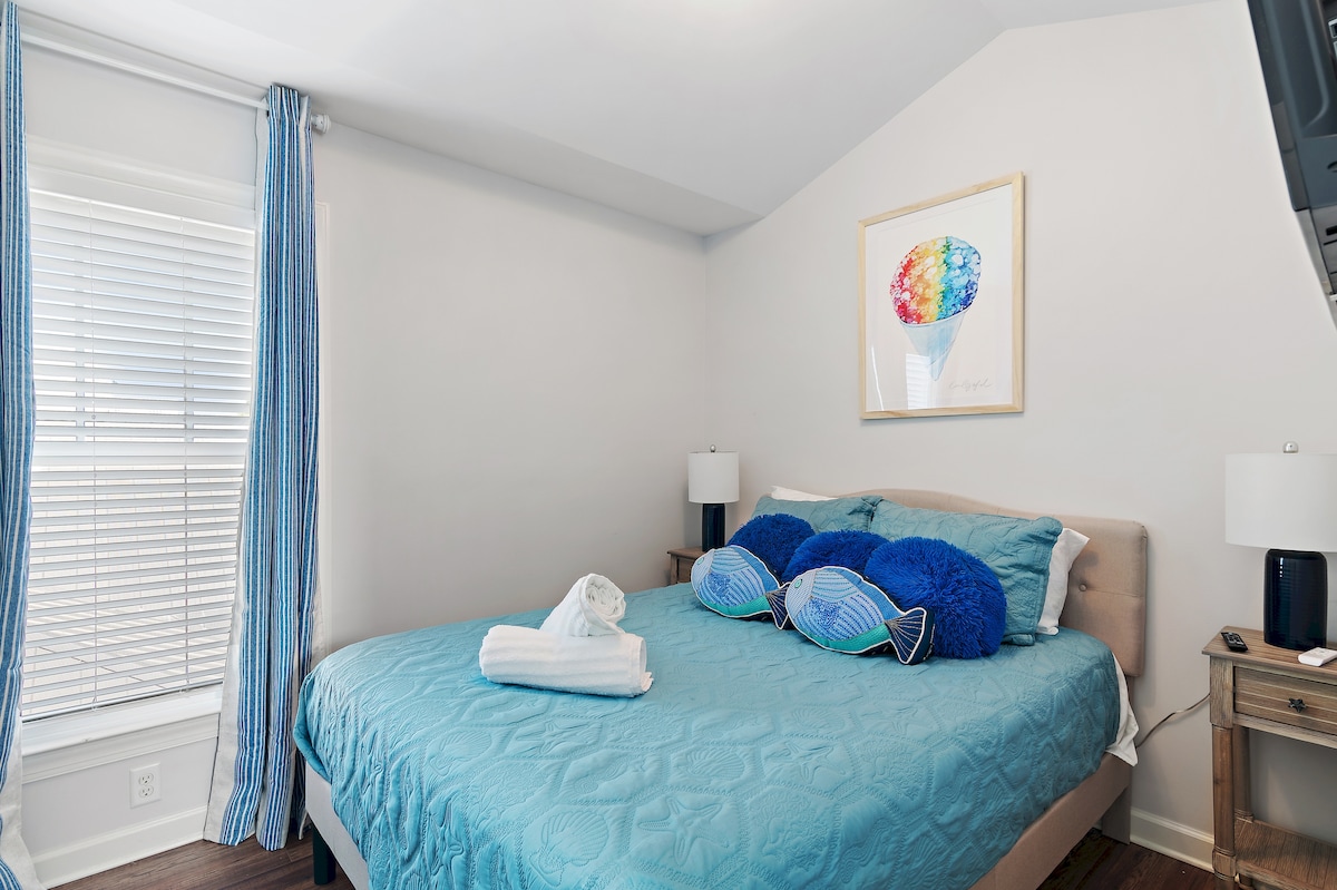The first 3rd floor bedroom has a queen bed, side tables, walk-in closet, ceiling fan, TV and more.