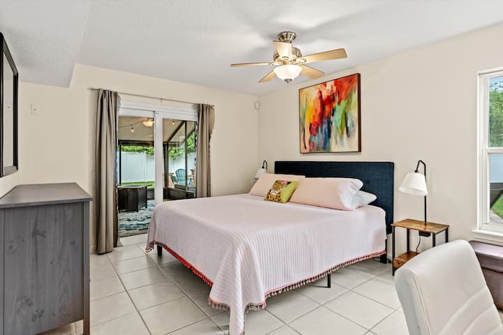 First floor primary bedroom with King bed, workspace, full bathroom, walk in closet AND access to the screened in patio!