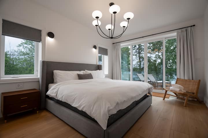 King sized bed on main level (2nd floor) with its own full bathroom and walk-out to deck.