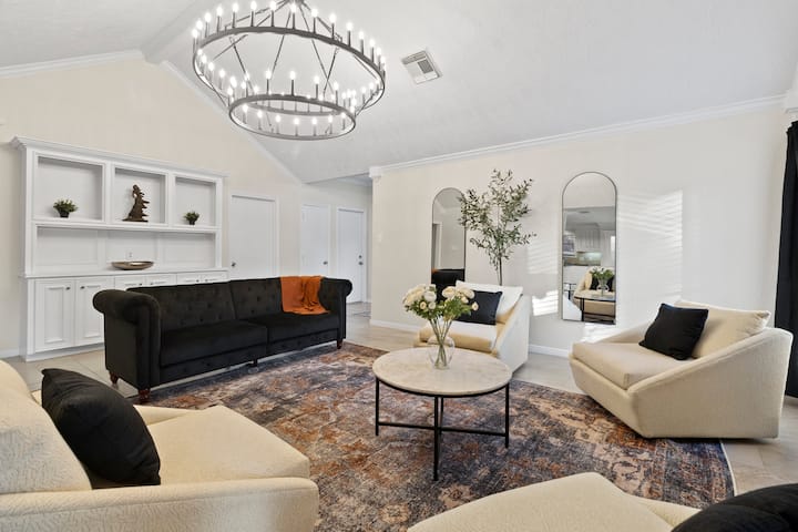 High ceilings with gorgeous upgraded lighting. Surround sound throughout that is bluetooth enabled to stream your favorite music. Spacious living room can double as an additional sleeping area. Black sofa folds flat into a full sized bed. 