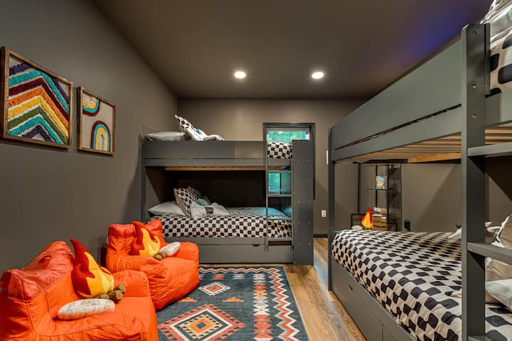 "The Retreat", a separate 3-bedroom area under the game room, offers 2 Queen Bedrooms (one with futon) and the kids' sanctuary, with kids' books, giant Jenga, and TV with four full-size beds to accommodate "kids" of all ages.
