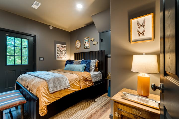 "The Retreat", second of two Queen bedrooms. This room also offers direct access to the back yard and speakeasy deck.