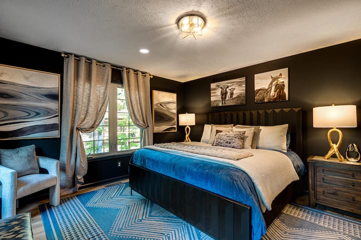 Experience the main level master bedroom, featuring a spacious ensuite bathroom and a private deck.