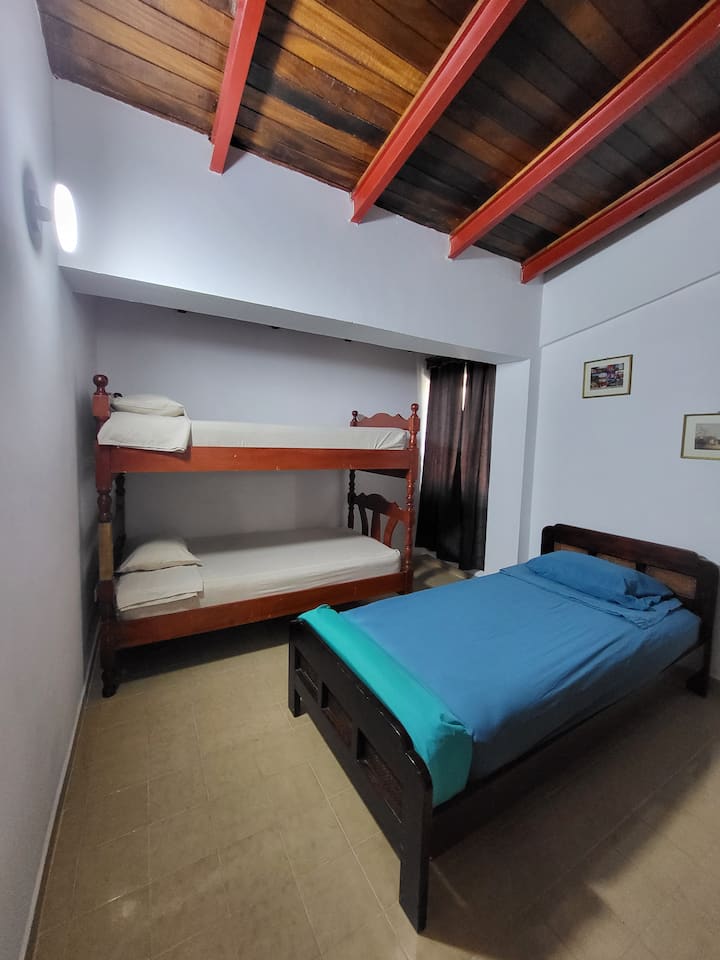Room 3, with a bunk bed and a single bed, is the perfect place to enjoy a fun and relaxing stay. With the curtains closed, a space for rest is created