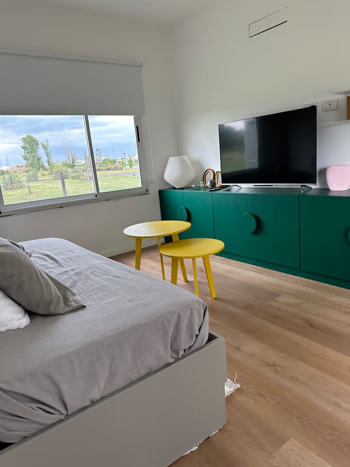 Ნიდო საწოლით (კალათა ქვემოთ), რომელიც, ასევე, შეიძლება გამოყენებულ იქნას, როგორც დამატებითი მისაღები ოთახი, 55"-იანი სმარტ-ტელევიზორით.