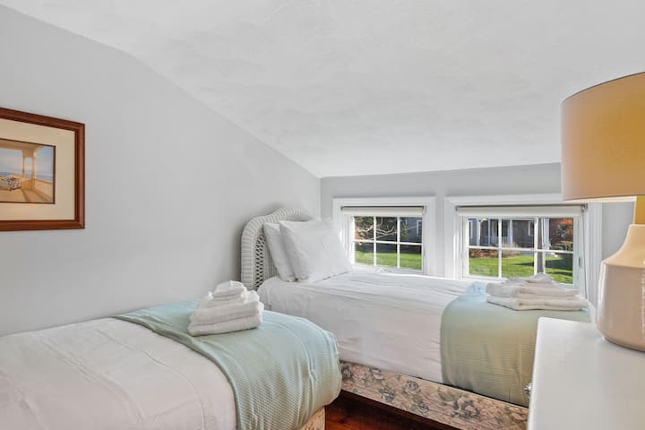 Second floor bedroom with two twin beds, two dressers, closet and hotel quality linens. 
